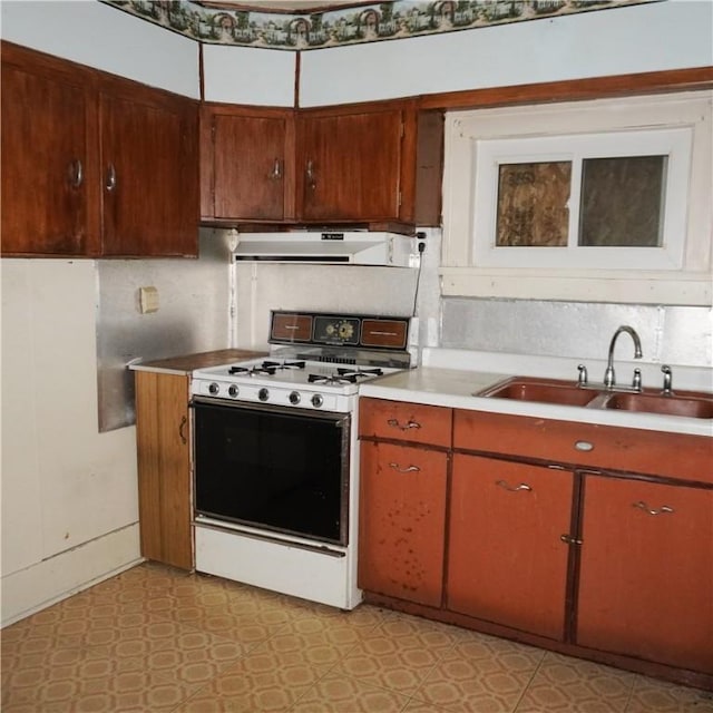 kitchen featuring sink and white gas range oven