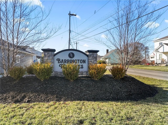 community / neighborhood sign with a yard