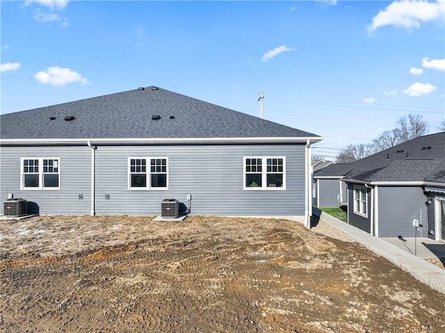 rear view of property featuring central AC unit