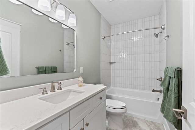 full bathroom with vanity, toilet, and tiled shower / bath combo