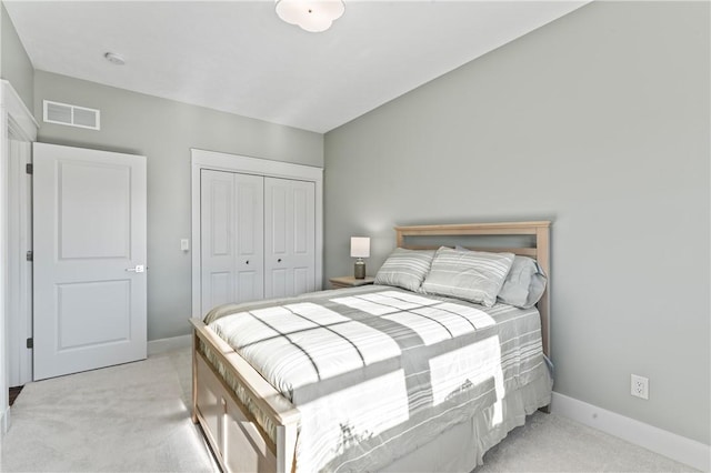 bedroom with light carpet and a closet