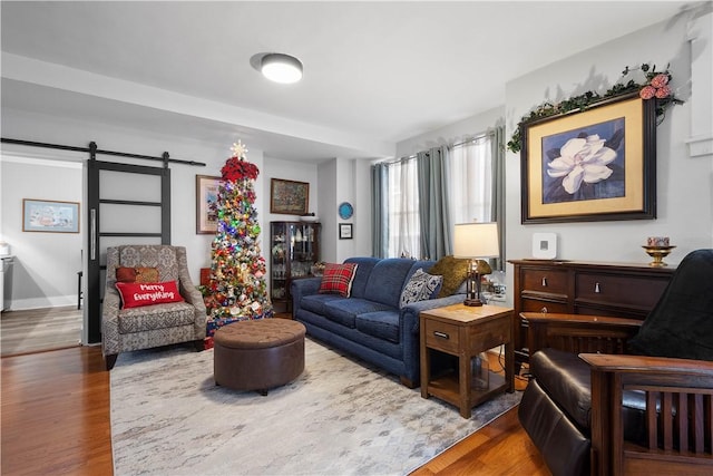 living room featuring a barn door and hardwood / wood-style flooring