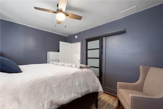 bedroom with ceiling fan and hardwood / wood-style flooring