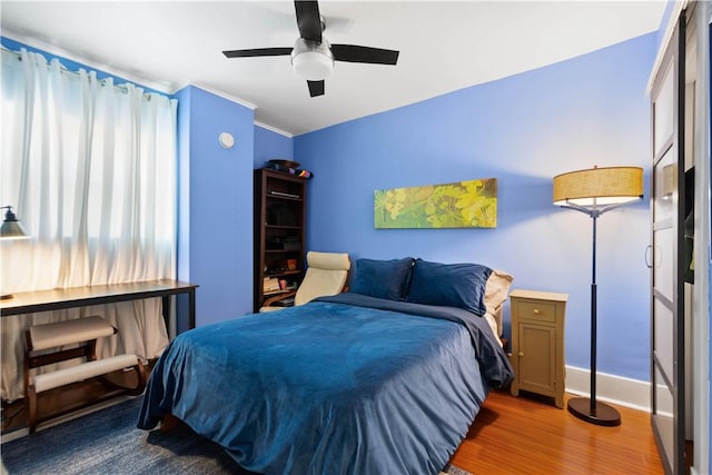 bedroom with hardwood / wood-style flooring and ceiling fan