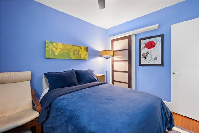 bedroom featuring ceiling fan and hardwood / wood-style floors