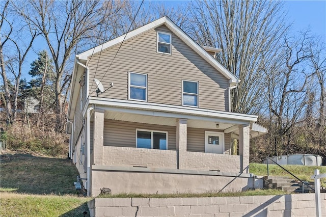 view of property featuring covered porch