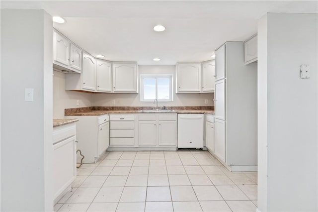 kitchen with white cabinetry, dishwasher, light tile patterned floors, and sink