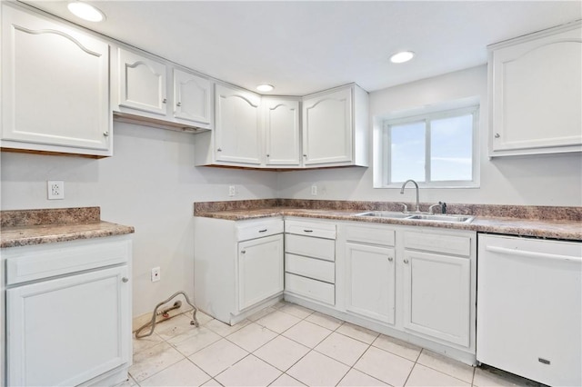 kitchen featuring white cabinetry, sink, white dishwasher, and light tile patterned floors