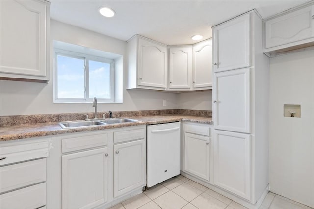 kitchen with dishwasher, white cabinetry, sink, and light tile patterned floors