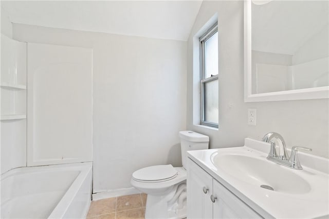 bathroom featuring toilet, tile patterned floors, vanity, and vaulted ceiling