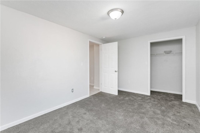 unfurnished bedroom with carpet floors and a closet