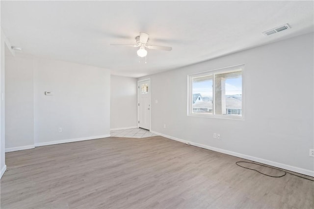 spare room with light hardwood / wood-style flooring and ceiling fan