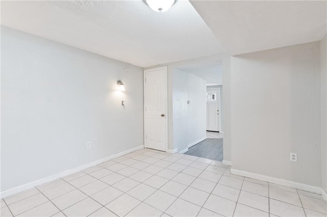 spare room featuring light tile patterned flooring