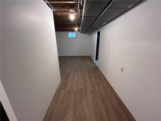 basement with hardwood / wood-style floors