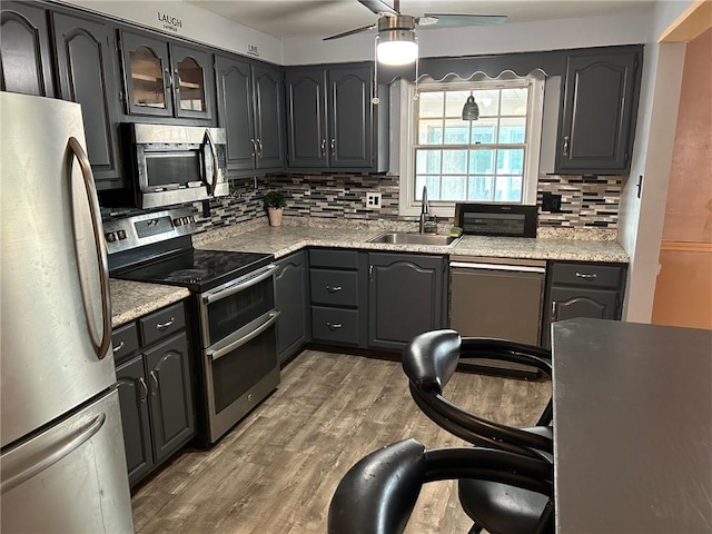 kitchen with decorative backsplash, sink, appliances with stainless steel finishes, and ceiling fan