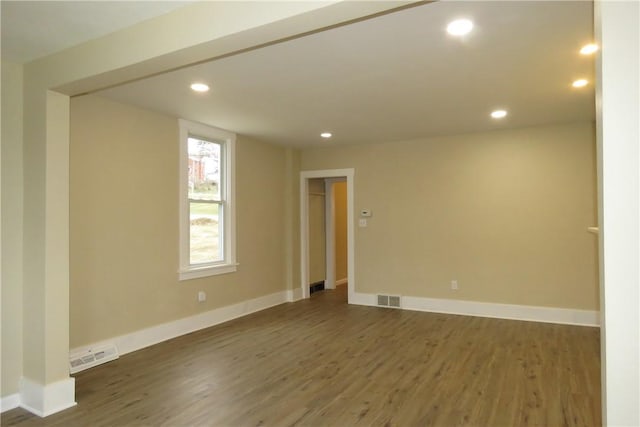 empty room with dark hardwood / wood-style flooring