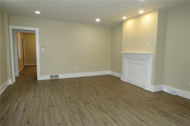 unfurnished living room with a fireplace and wood-type flooring