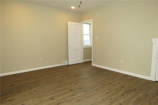 unfurnished room with dark hardwood / wood-style floors