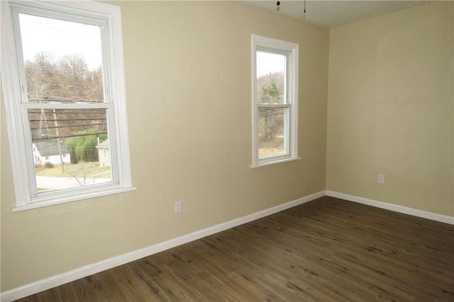 spare room featuring dark hardwood / wood-style flooring