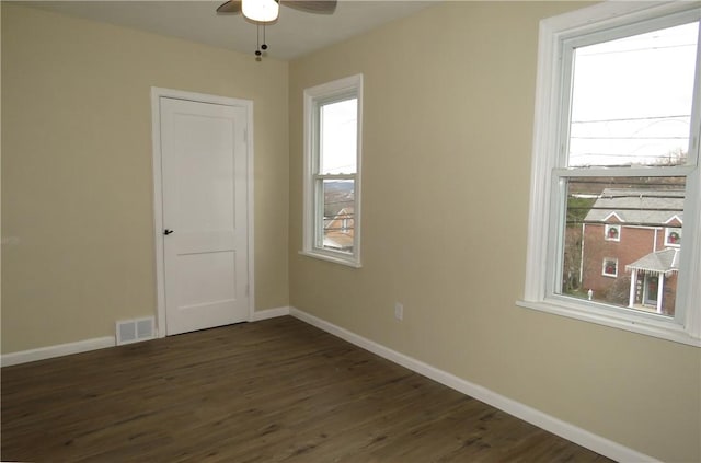 spare room with ceiling fan and dark hardwood / wood-style flooring