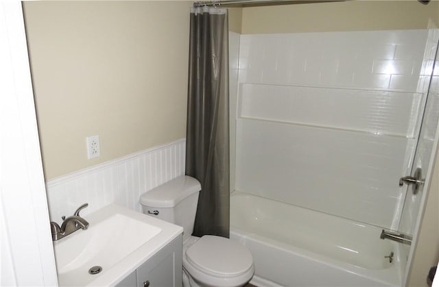 full bathroom with vanity, shower / bath combo, and toilet