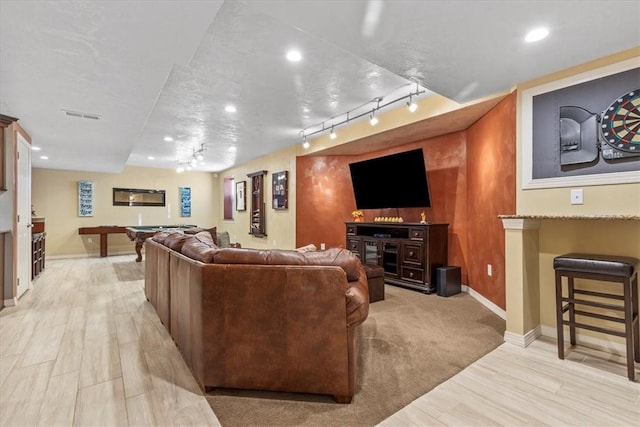 living room featuring light hardwood / wood-style flooring, track lighting, and billiards