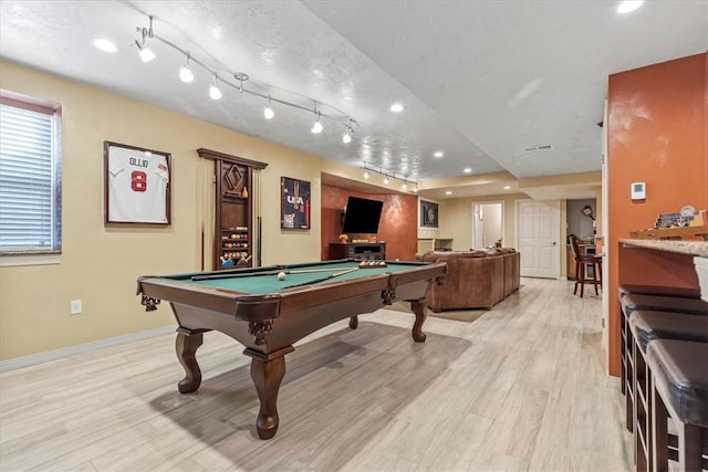 recreation room with a textured ceiling, light hardwood / wood-style flooring, track lighting, and billiards