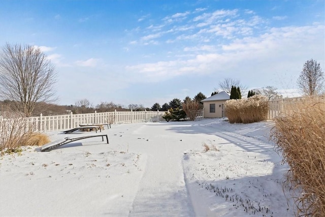 yard covered in snow with fence