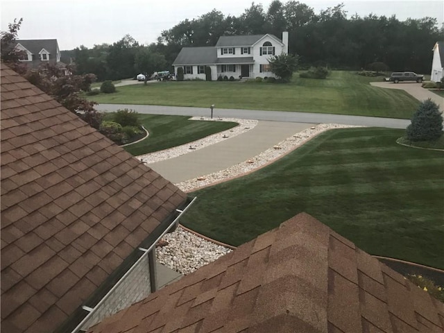 view of home's community featuring a lawn