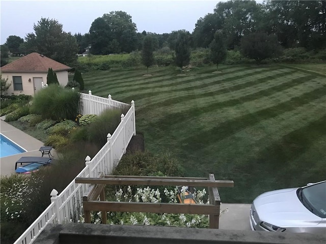 view of yard with fence and a fenced in pool