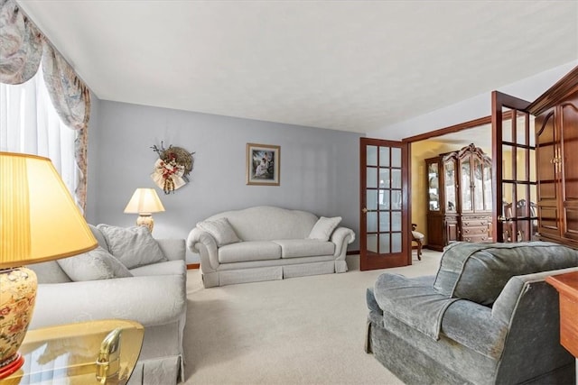 living room featuring french doors and carpet floors