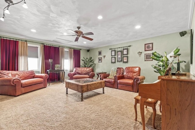 living room featuring carpet flooring, ceiling fan, a textured ceiling, and ornamental molding