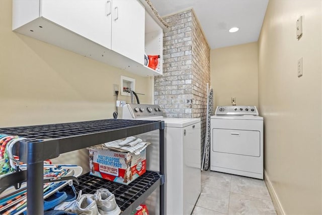 clothes washing area with light tile patterned floors, recessed lighting, separate washer and dryer, baseboards, and cabinet space