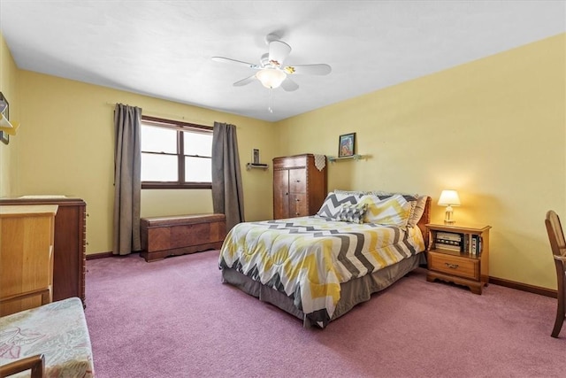 carpeted bedroom with ceiling fan and baseboards