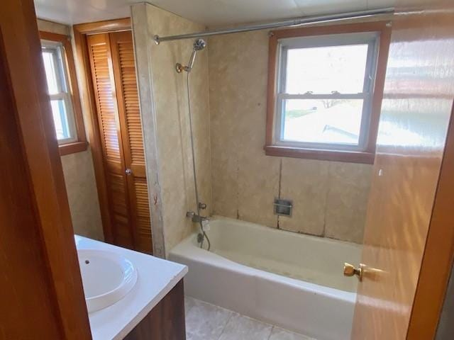 bathroom featuring tile patterned flooring, vanity, and shower / bathtub combination