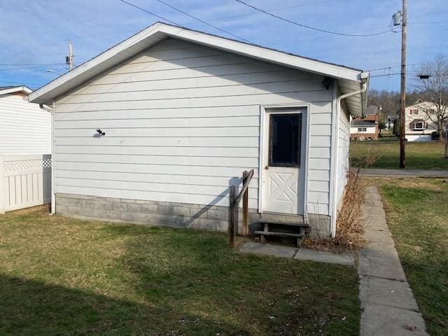 view of side of home with a lawn