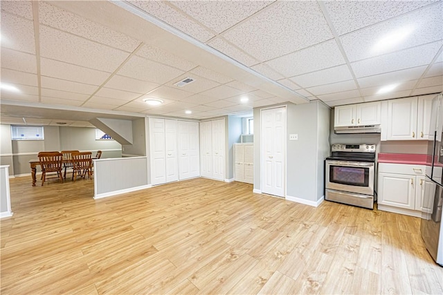 kitchen with electric range, a paneled ceiling, light hardwood / wood-style floors, and white cabinetry