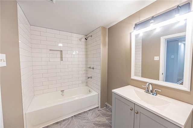 bathroom with vanity and tiled shower / bath combo