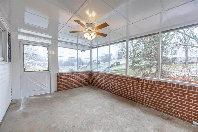 unfurnished sunroom featuring ceiling fan