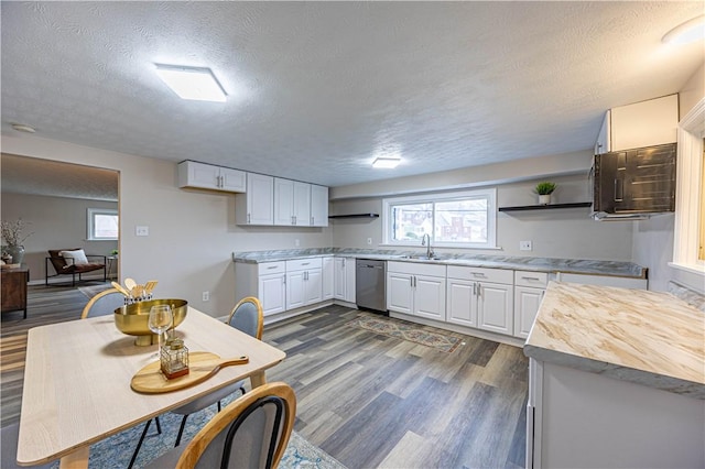 kitchen with white cabinets, dark hardwood / wood-style floors, and a textured ceiling