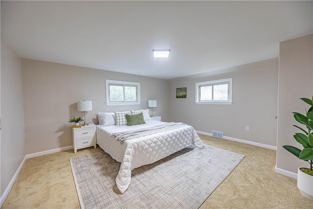 carpeted bedroom featuring multiple windows