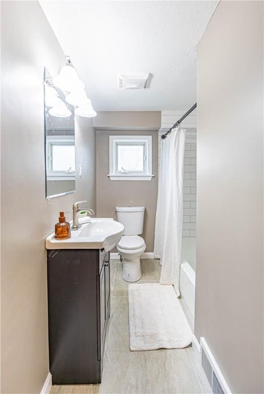 full bathroom featuring vanity, shower / bath combination with curtain, and toilet