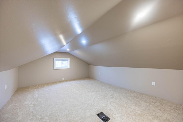 bonus room featuring carpet and vaulted ceiling