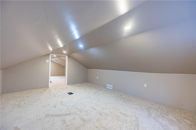 bonus room featuring carpet and vaulted ceiling