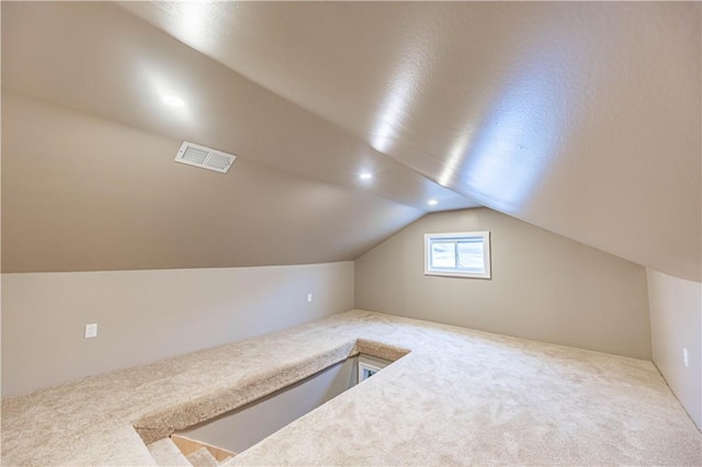 bonus room featuring carpet floors and vaulted ceiling