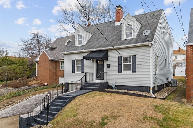 new england style home featuring central AC and a front lawn