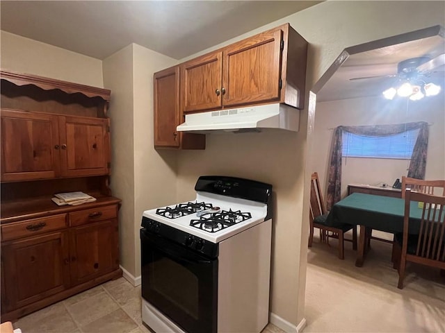 kitchen featuring ceiling fan and white gas stove