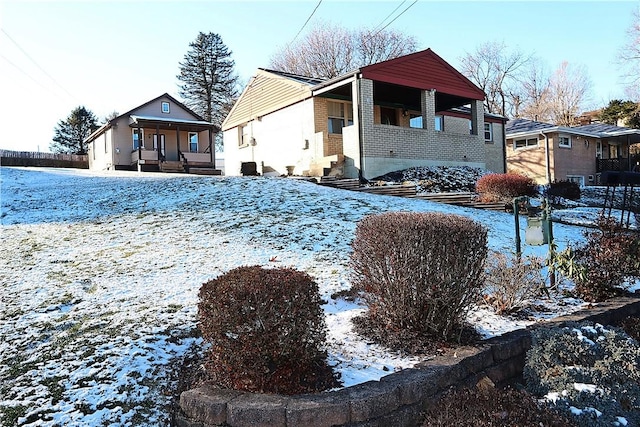 view of snow covered exterior with a porch