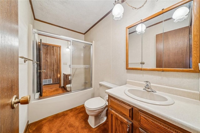 full bathroom with combined bath / shower with glass door, crown molding, a textured ceiling, toilet, and vanity