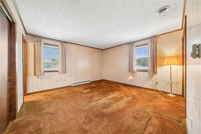 carpeted spare room featuring a baseboard radiator and a textured ceiling